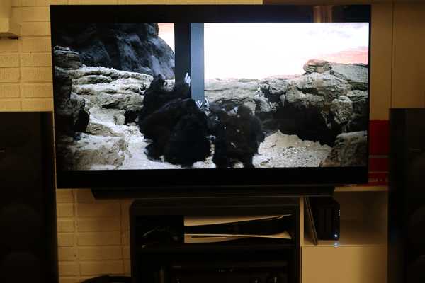 A server next to a TV playing a scene in '2001: A Space Odyssey' where apes are interacting with an alien monolith